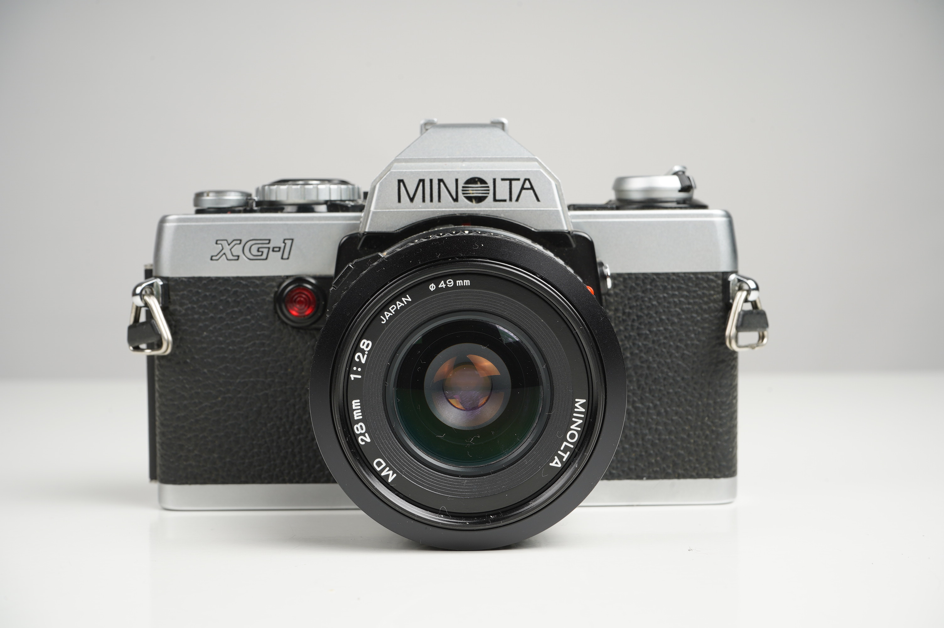 Gebraucht Minolta XG-1 + MD 28mm F2.8  | Gut erhalten - normale Gebrauchsspuren | inkl. Gegenlichtblende/Riemen/Betriebsanleitung |