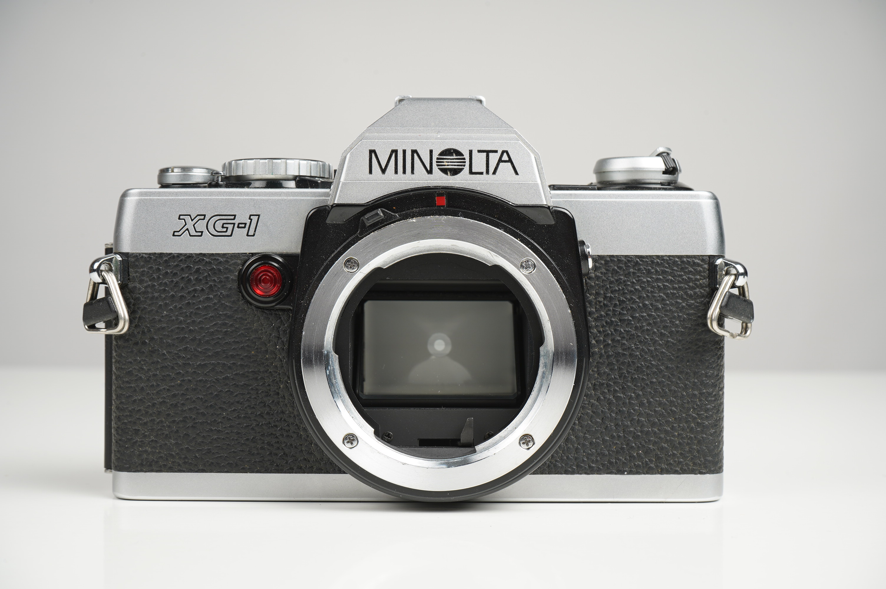 Gebraucht Minolta XG-1 + MD 28mm F2.8  | Gut erhalten - normale Gebrauchsspuren | inkl. Gegenlichtblende/Riemen/Betriebsanleitung |